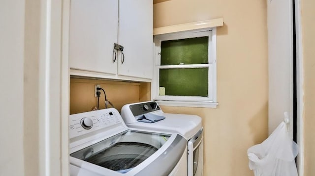 laundry room with cabinets and washer and dryer