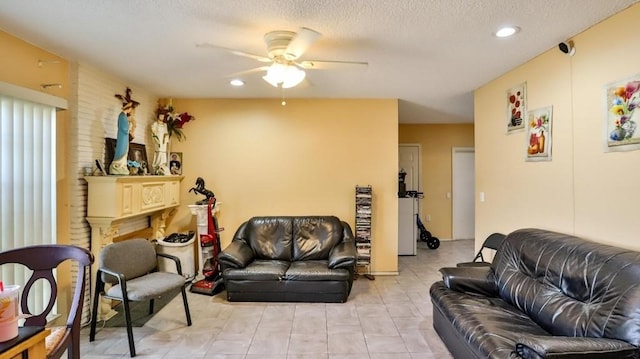 living room with a textured ceiling and ceiling fan