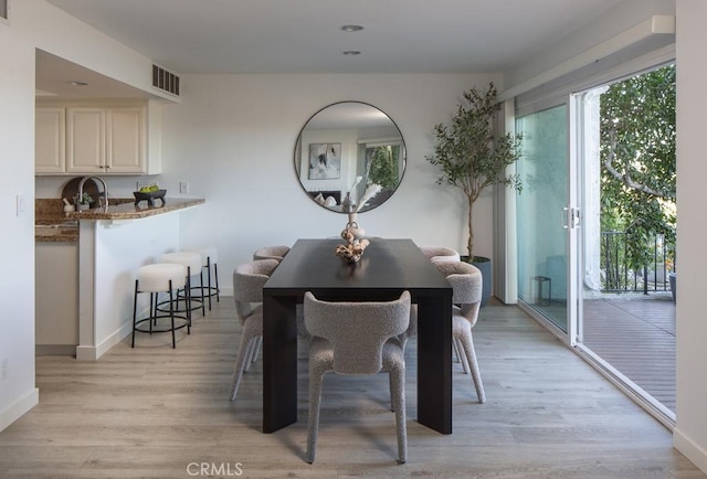 dining area featuring light wood-type flooring