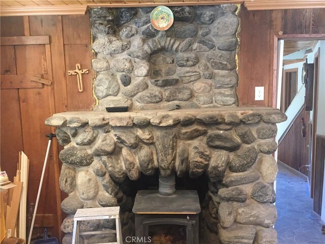 interior details with wood walls and a wood stove