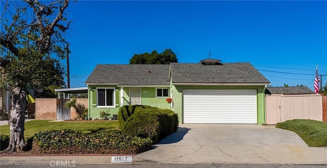 view of front of home featuring a front lawn and a garage