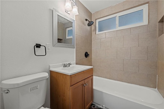 full bathroom featuring toilet, vanity, and tiled shower / bath combo