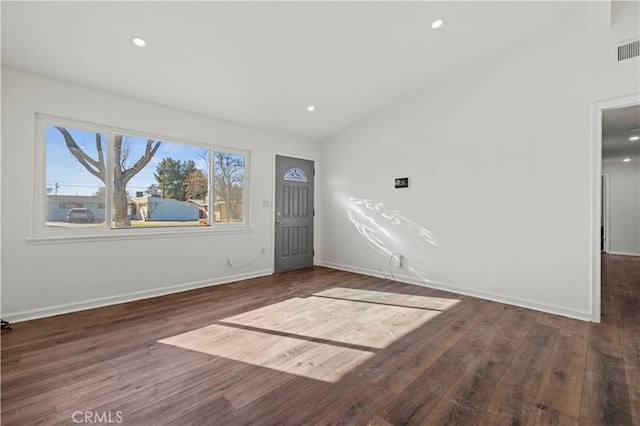 entryway with dark wood-type flooring and lofted ceiling