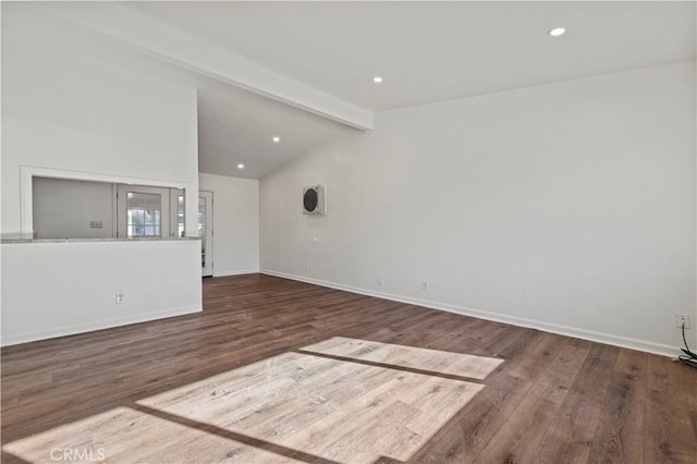 unfurnished living room with vaulted ceiling with beams and hardwood / wood-style flooring