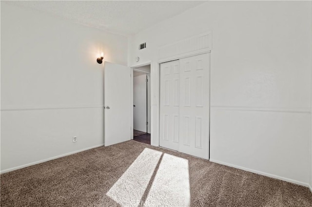 unfurnished bedroom featuring a closet and carpet