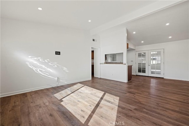 unfurnished living room with dark wood-type flooring, french doors, and lofted ceiling with beams