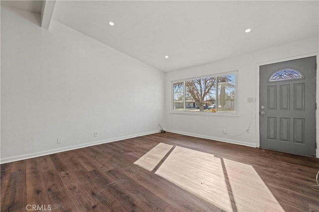 entrance foyer with lofted ceiling with beams and dark hardwood / wood-style floors