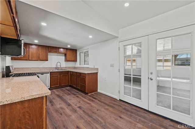 kitchen featuring dishwasher, dark wood-type flooring, french doors, light stone counters, and sink