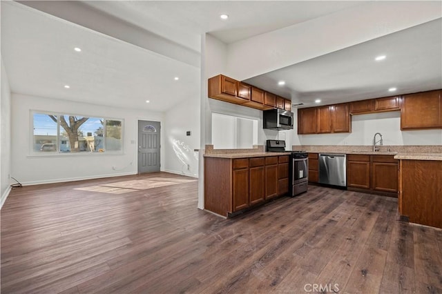 kitchen featuring stainless steel appliances, dark hardwood / wood-style flooring, and sink