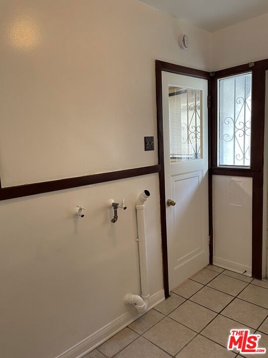 doorway with light tile patterned flooring