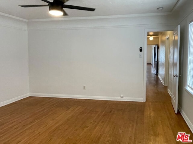 spare room with hardwood / wood-style flooring, ornamental molding, and ceiling fan