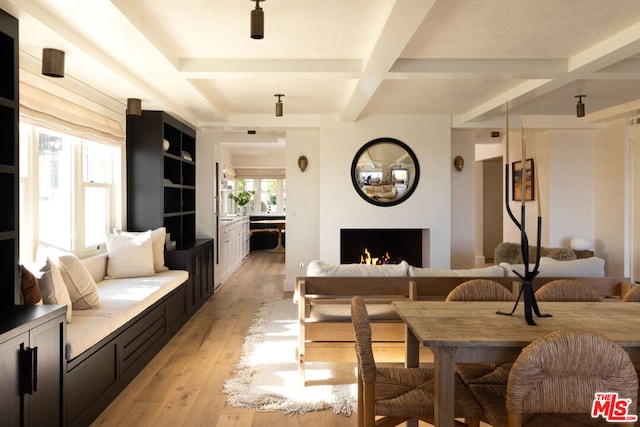 interior space featuring light wood-type flooring, beam ceiling, and coffered ceiling