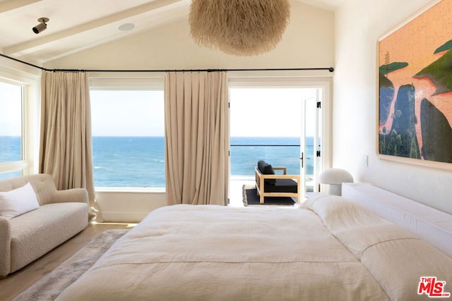 bedroom featuring vaulted ceiling, wood-type flooring, and a water view