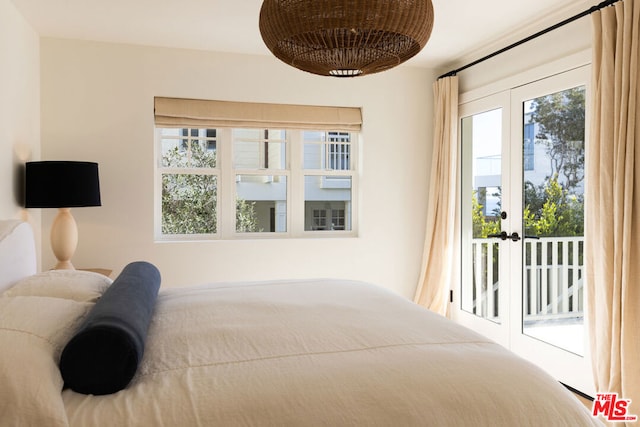 bedroom featuring french doors, access to exterior, and multiple windows