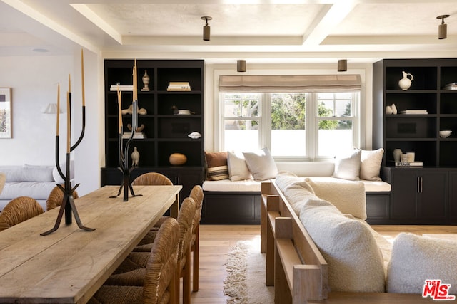 living room featuring light wood-type flooring and built in shelves