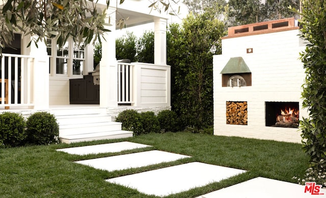 view of yard with exterior fireplace