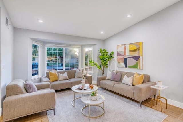 living room with lofted ceiling and hardwood / wood-style flooring