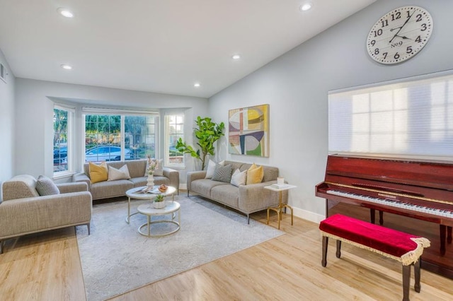 living room with vaulted ceiling and hardwood / wood-style flooring