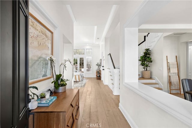 hall featuring light hardwood / wood-style floors and crown molding