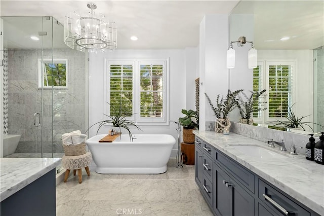 bathroom with vanity, a chandelier, plenty of natural light, and plus walk in shower