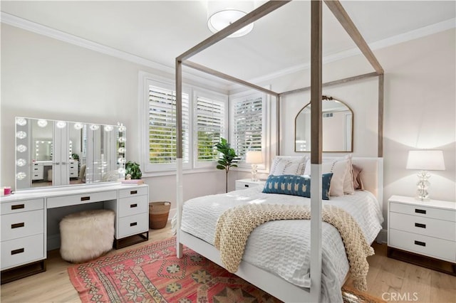 bedroom with ornamental molding and light hardwood / wood-style flooring