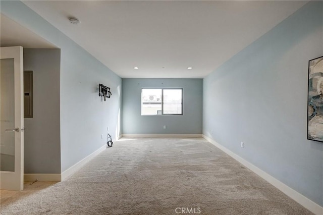 carpeted spare room featuring electric panel