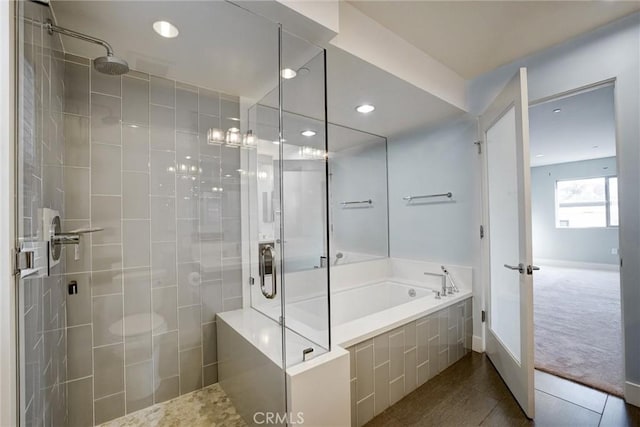 bathroom featuring tile patterned flooring and shower with separate bathtub