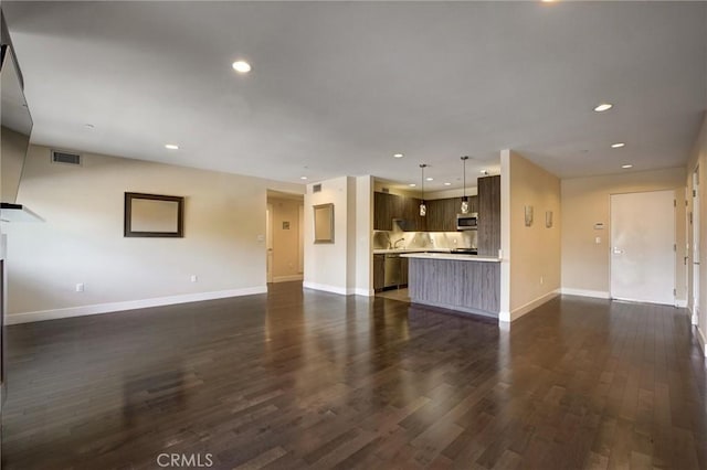 unfurnished living room with dark hardwood / wood-style flooring