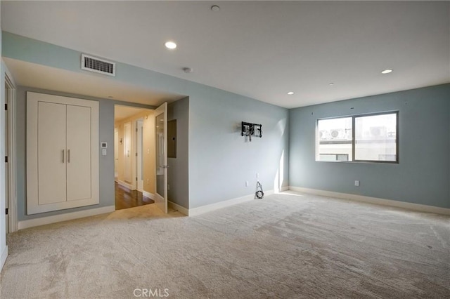 carpeted spare room featuring electric panel