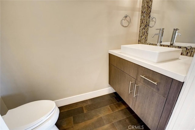 bathroom with toilet, vanity, and tile patterned floors