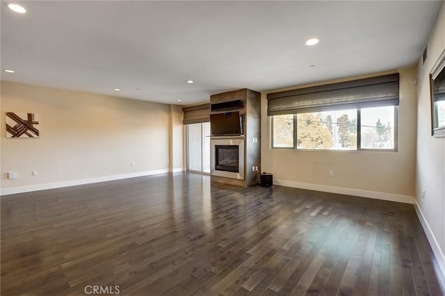 unfurnished living room with dark hardwood / wood-style floors