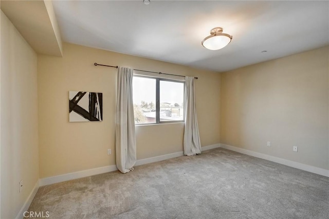 spare room featuring light colored carpet