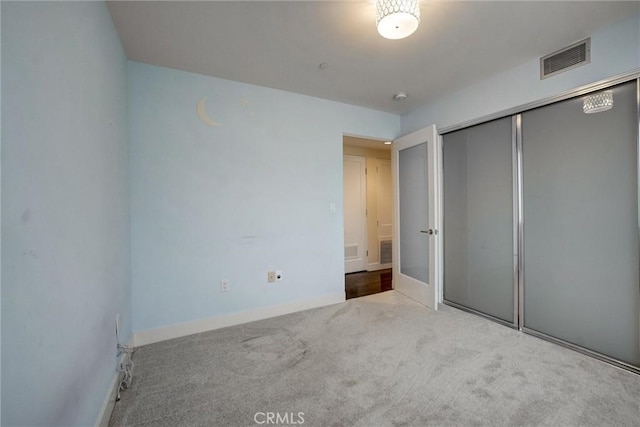 unfurnished bedroom featuring a closet and carpet flooring