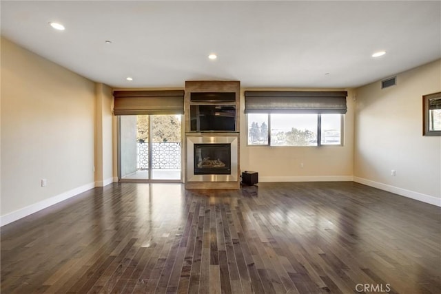 unfurnished living room featuring dark hardwood / wood-style floors