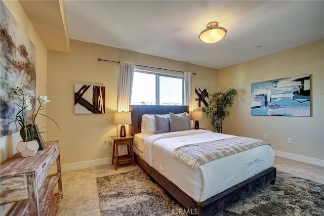 bedroom with light carpet and baseboards