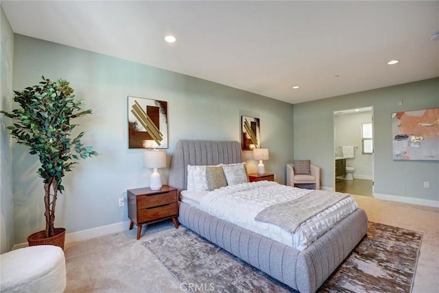 carpeted bedroom with ensuite bathroom, baseboards, and recessed lighting