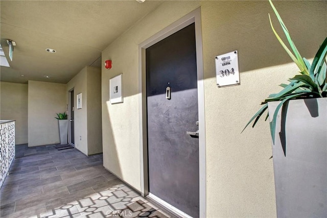 entrance to property with stucco siding