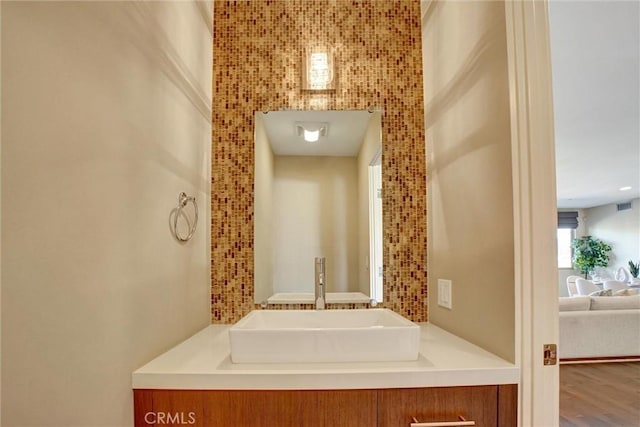 bathroom featuring wood finished floors, vanity, and visible vents