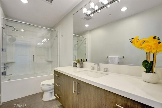 bathroom featuring tile patterned floors, toilet, vanity, enclosed tub / shower combo, and visible vents