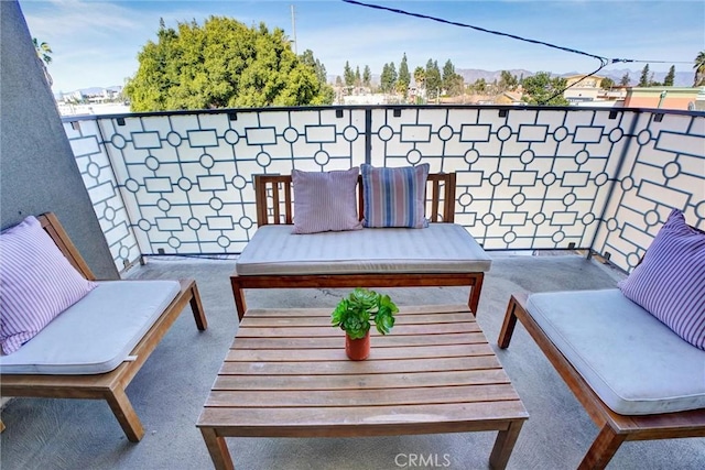 balcony with an outdoor living space and a patio