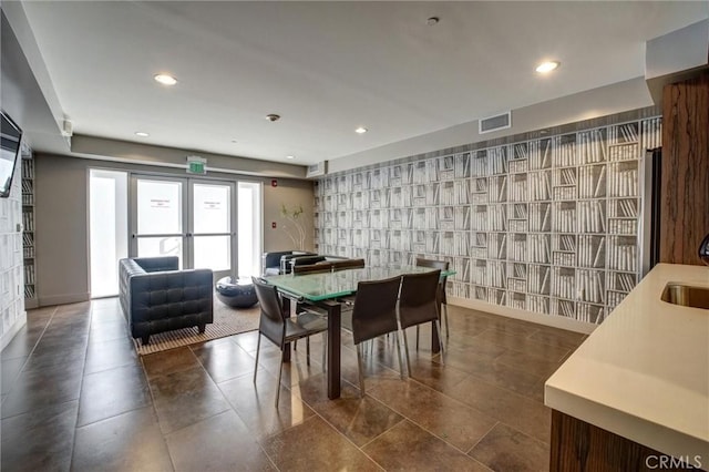 dining space with baseboards, visible vents, wallpapered walls, and recessed lighting