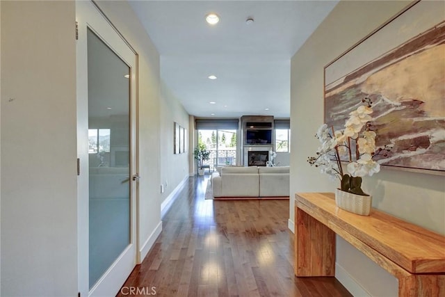 hall with recessed lighting, wood finished floors, and baseboards