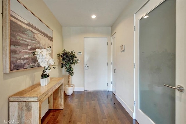 interior space with baseboards, dark wood-style flooring, and recessed lighting
