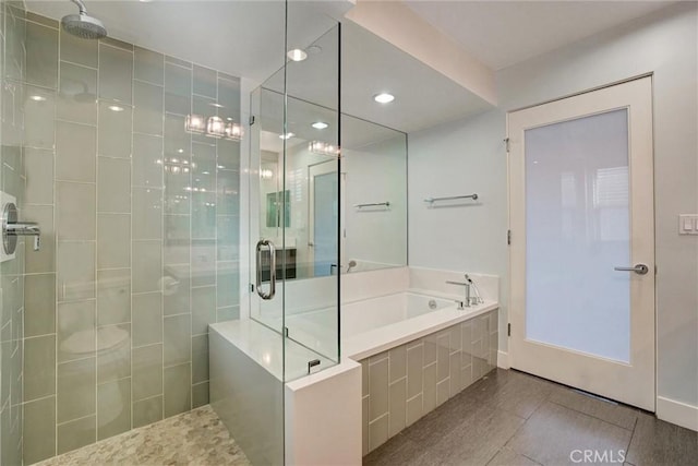 full bathroom featuring a garden tub, tile patterned floors, and a shower stall