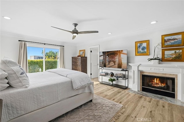 bedroom featuring crown molding, ceiling fan, access to outside, and light wood-type flooring