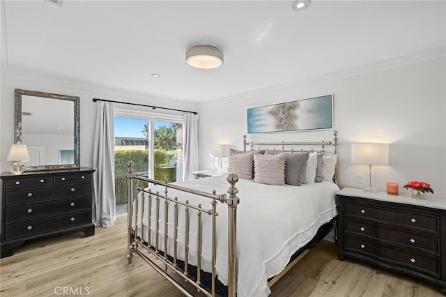 bedroom with crown molding and light hardwood / wood-style flooring