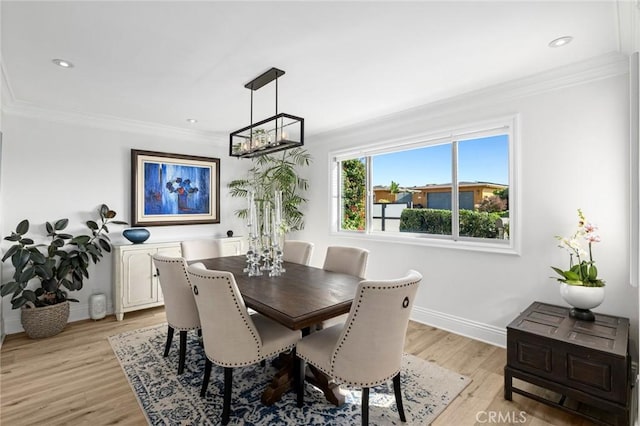 dining room featuring light wood-type flooring and ornamental molding