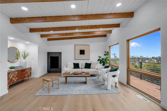 living room with wooden ceiling, a fireplace, vaulted ceiling with beams, and light hardwood / wood-style flooring