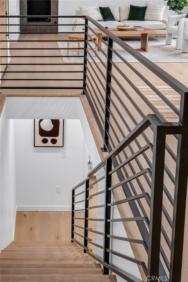 staircase with hardwood / wood-style flooring