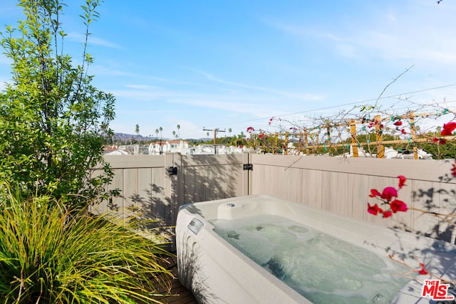 view of patio / terrace with a hot tub